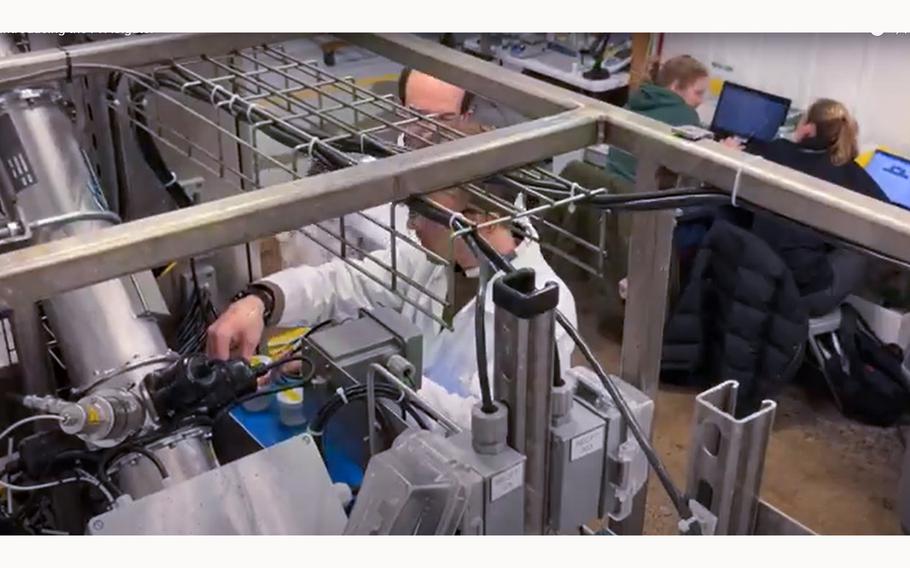 A video screen grab shows technicians at a Lansing-Michigan site working on a system that employs a novel technology that purports to destroy PFAS in water.