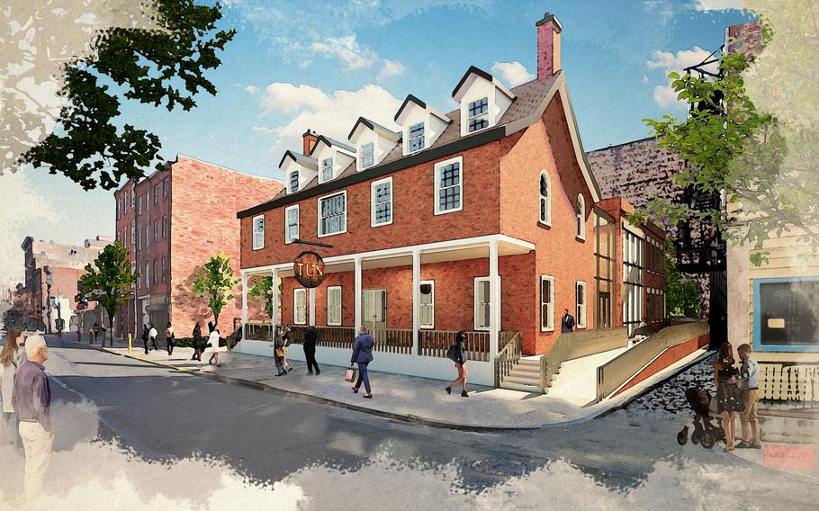 A red brick building with a wraparound porch and wheelchair friendly ramp is shown.