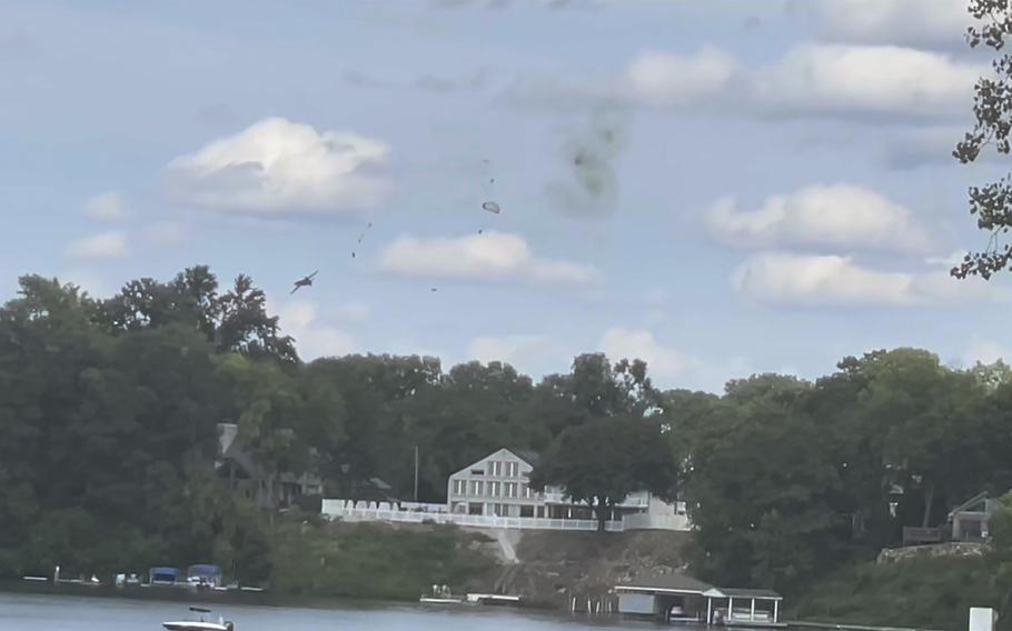 This image provided by Michelle Quezada shows a jet crashing during an air show on Sunday, Aug. 13, 2023. A pilot and crew member escaped serious injury when they ejected from a vintage jet that crashed, officials said. 