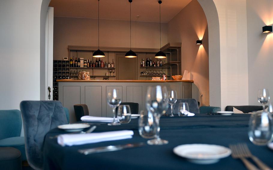 A bar sits in an intimate room with one table and various chairs at L'intuition in Houdeng-Aimeries, Belgium, on Aug. 29, 2024.