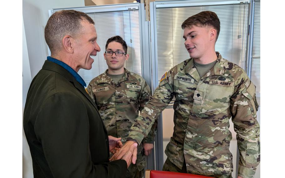 CEO of Army Emergency Relief Tony Grinston greets soldiers during a trip to Italy