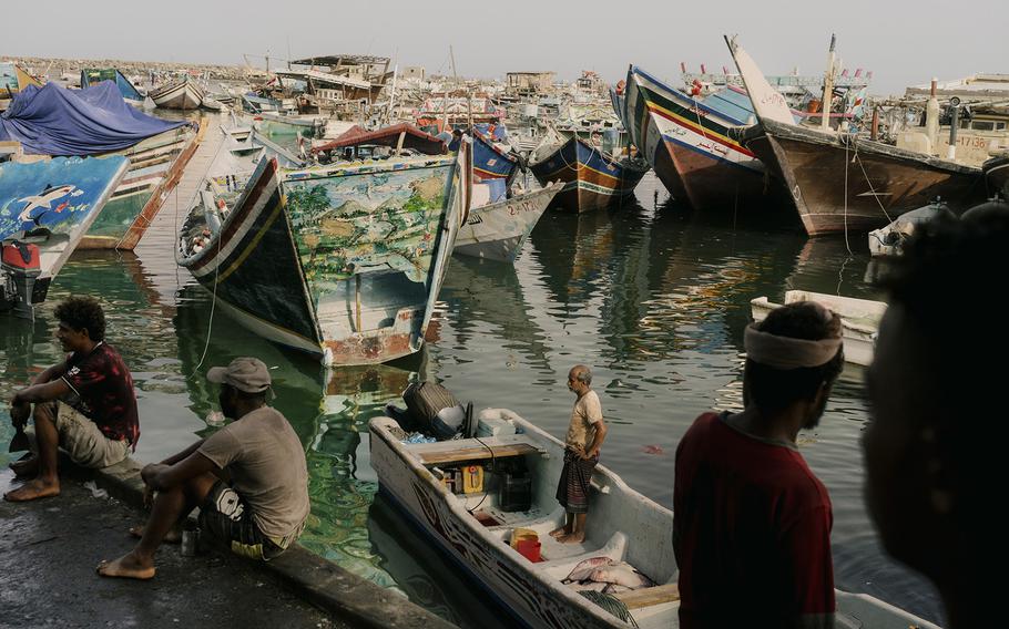 Fishermen, resting after a night at sea, are working shorter hours to avoid dehydration and sunburn. 