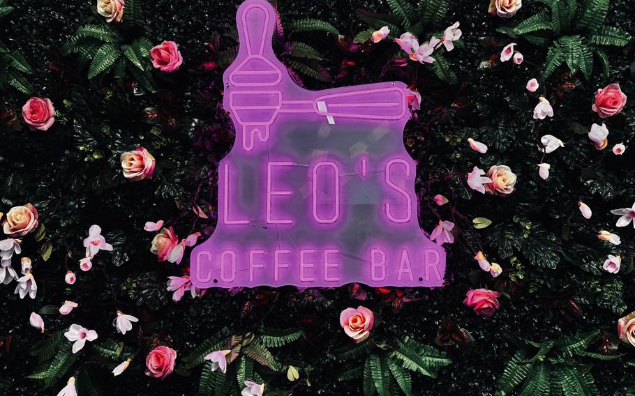 A Leo’s Coffee Bar sign is displayed in pink neon.