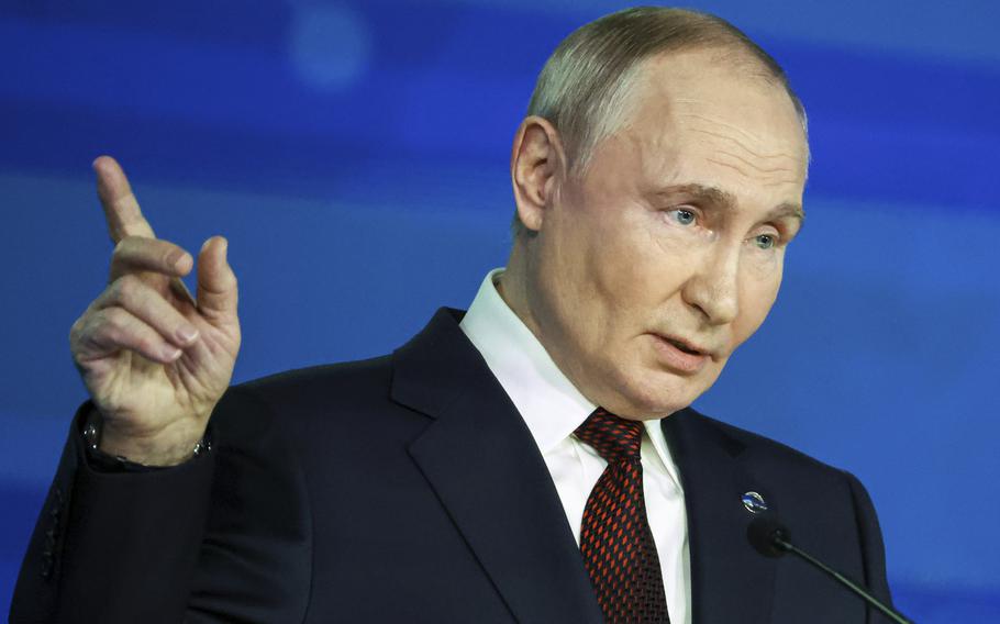 Russian President Vladimir Putin points during a meeting