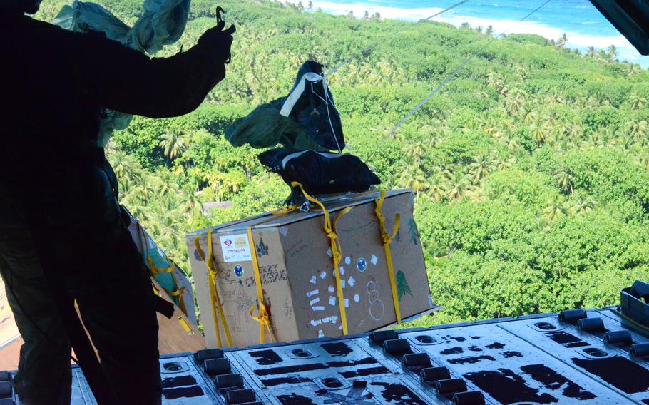 Airmen from Yokota Air Base, Japan, sends Operation Christmas Drop bundles to islanders.