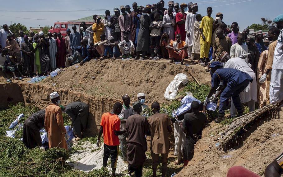 A group helps prepare bodies for burial in Nigeria. They were killed in a tanker explosion.