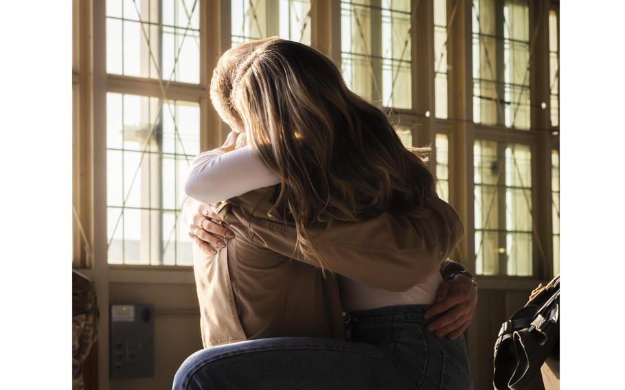 Airman embraces a loved one