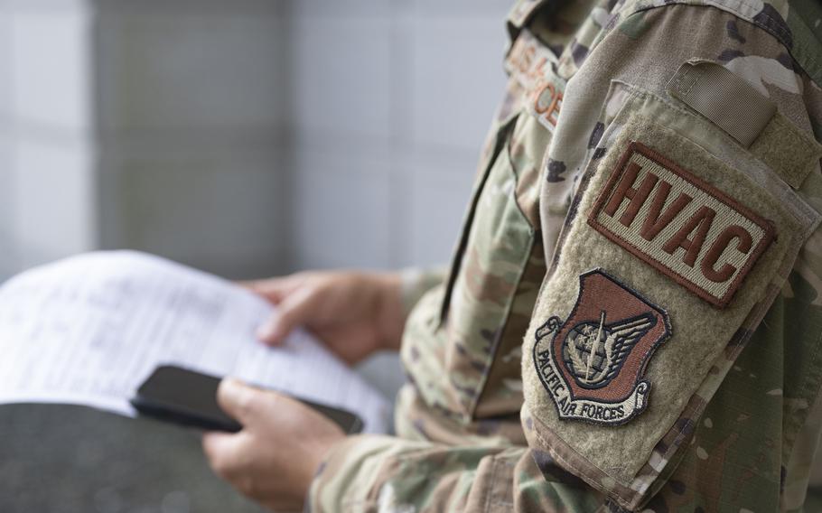 Senior Airman Intorn Messa of the 8th Civil Engineer Squadron reviews an HVAC work order at Kunsan Air Base, South Korea, on Aug. 8, 2024.