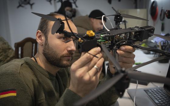 A man inspects a drone.