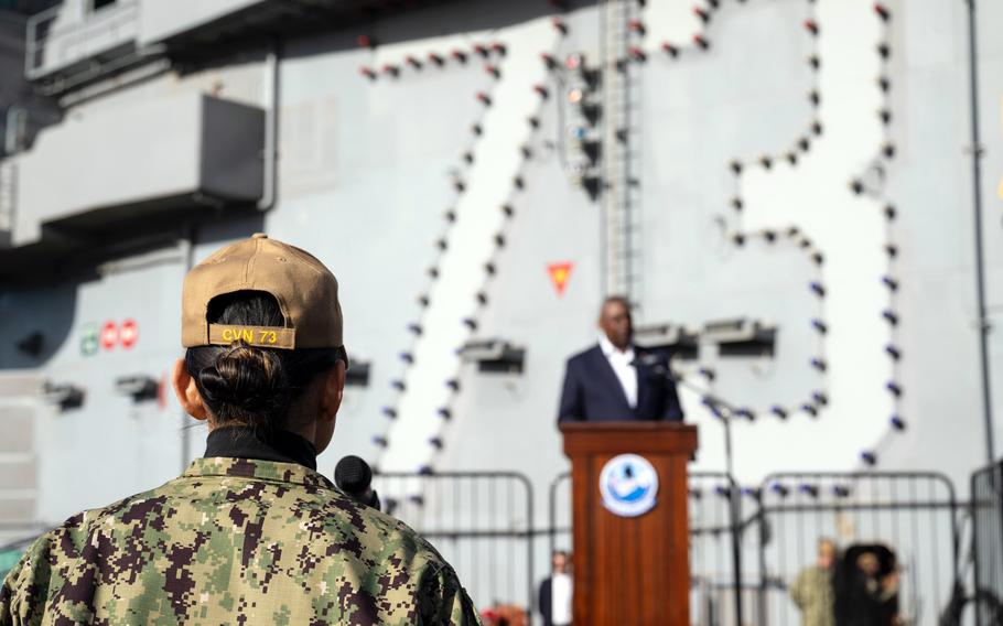 Secretary of Defense Lloyd Austin speaks to sailors aboard the aircraft carrier USS George Washington at Yokosuka Naval Base.