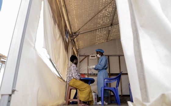 FILE - A health worker attends to a mpox patient, at a treatment centre in Munigi, eastern Congo, Monday, Aug. 19, 2024.   (AP Photo/Moses Sawasawa, File)