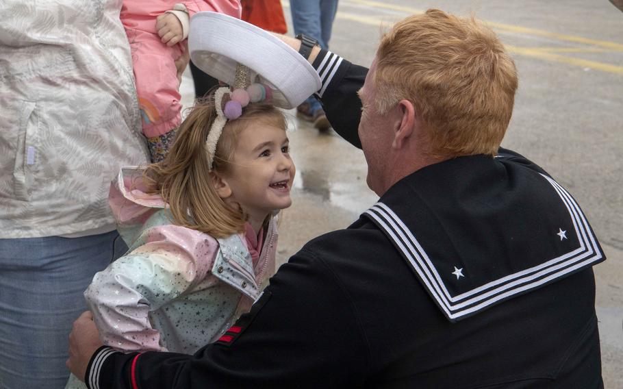 Petty Officer 2nd Class David Gaddis, assigned to the destroyer USS Oscar Austin, greets his family during the ship's homeport shift to Naval Station Rota, Spain, from Naval Station Norfolk, Va., Oct. 15, 2024.