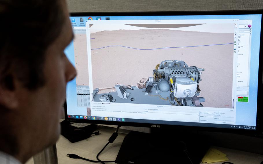 A NASA worker watches the Mars rover on his computer screen.