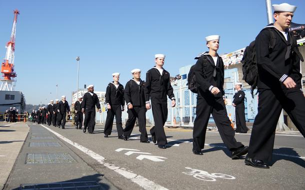 Sailors disembark the USS George Washington after arriving at the aircraft carrier's new homeport, Yokosuka Naval Base, Japan, Nov. 22, 2024.

