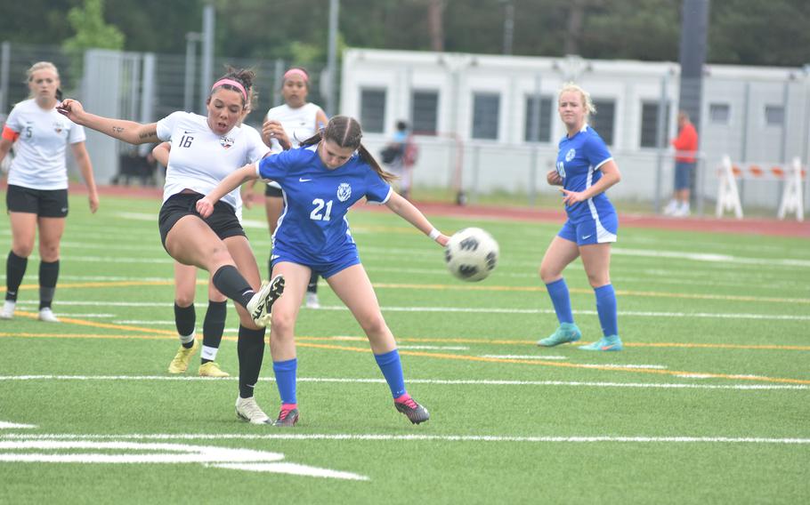 Stuttgart's Serenity Brown boots the ball away from Ramstein's Olivia Davis in the championship game of the DODEA European Division I girls soccer tournament Thursday, May 23, 2024, at Ramstein High School in Germany.