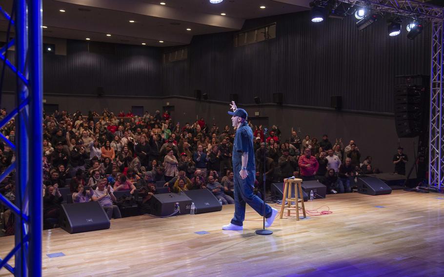 Jo Koy walks out on stage and greets a crowd of people.