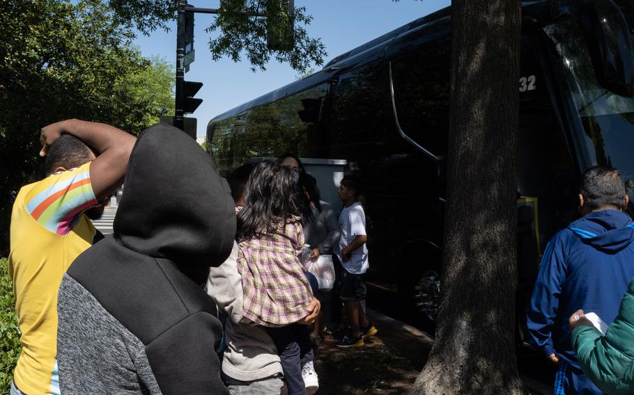 Migrants gather in D.C. after arriving on a bus from Arizona on April 18.