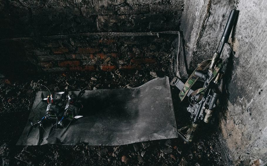 Drones and an M4 rifle belonging to members of the Alpha unit.