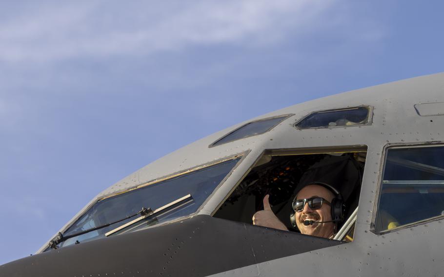 Airman thumbs up from the cockpit of an aircraft