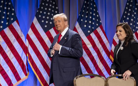 President-elect Donald Trump walks into a meeting with Rep. Elise Stefanik behind him.