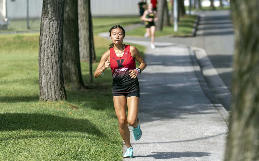 Nile C. Kinnick senior Mia Bartram leaves Robert D. Edgren freshman Reagan Keller behind during Saturday's DODEA-Japan cross-country race. Bartram and Keller finished 1-2.