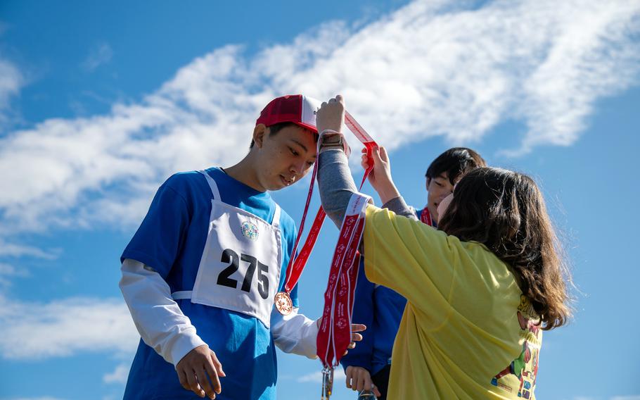 A Japanese athlete is awarded a medal