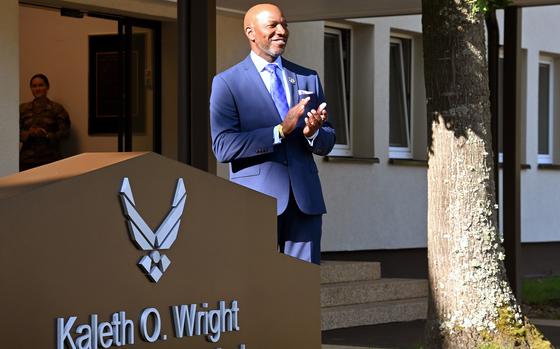 Retired Chief Master Sgt.of the Air Force Kaleth O. Wright claps after he helped unveil the sign that names the airman leadership school after him during a ceremony at Kapaun Air Station in Kaiserslautern, Germany, Sept. 19, 2024.