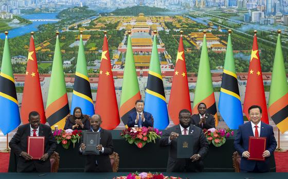 In this photo released by Xinhua News Agency, real from left, Tanzania's President Samia Suluhu Hassan, Chinese President Xi Jinping and Zambia President Hakainde Hichilema applaud as they witness the signing of a memorandum of understanding on the revitalisation project of the Tanzania-Zambia Authority railway, at the Great Hall of the People in Beijing, Wednesday, Sept. 4, 2024, ahead of the China Africa Forum. (Zhai Jianlan/Xinhua via AP)