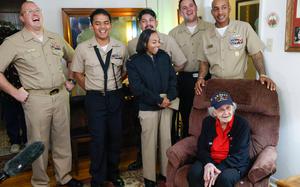 Sailors from the USS Fort Worth laugh with Navy World War II veteran Elsie Kitty Rippin after they surprised her with cake and gift for her 101st birthday on Monday, Feb. 3, 2025, in Haltom City. Rippin celebrated her 101st birthday on Jan. 31.