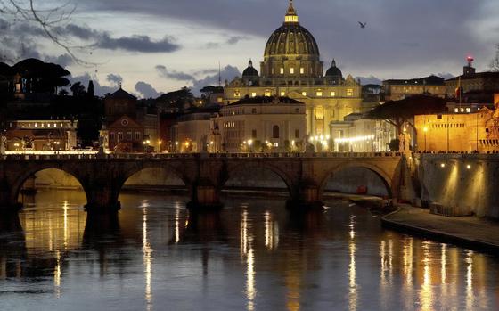 St. Peter's Basilica at The Vatican is seen at dusk across the river Tiber in Rome, Italy Friday, Feb. 28, 2025. (AP Photo/Kirsty Wigglesworth)