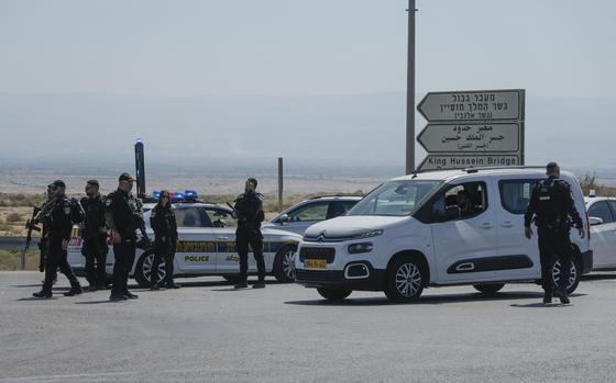 Israeli police stand guard near the site of a deadly shooting attack where Israeli officials say three people were shot and killed at the Allenby Bridge Crossing between the West Bank and Jordan, Sunday, Sept. 8, 2024. (AP Photo/Mahmoud Illean)