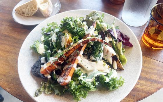 The grilled mixed vegetable salad from Farm Basel in Hachioji, Japan, is a mix of arugula, lettuce, kale and carrots, peppers and eggplant from Nakanishi Farm and topped with a creamy dressing with ingredients from Isonuma Milk Farm. 