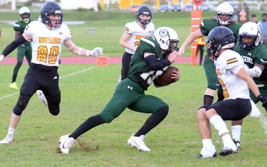 Kubasaki's Lukas Gaines looks for space to run between ASIJ defenders Oskar Vermiere and Alex Moores.