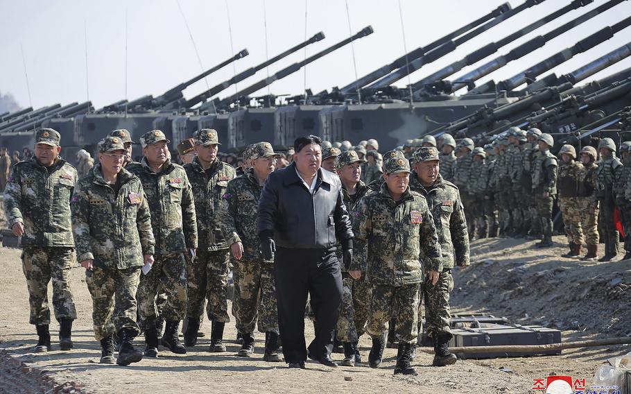 Kim Jong Un and North Korean troops during artillery drills.