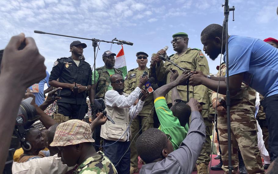 A soldier with Niger’s ruling junta speaks to junta supporters, Aug. 6, 2023. 