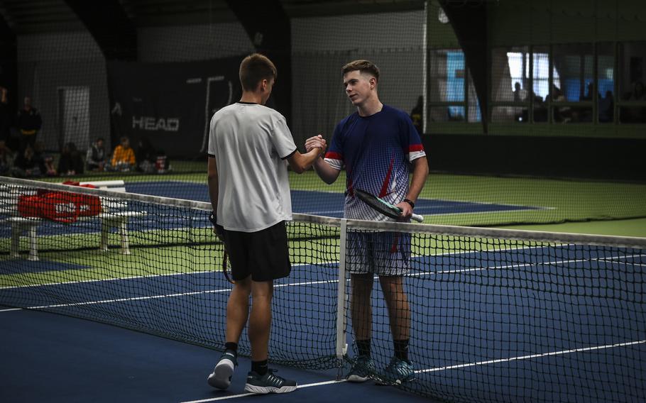 Kaiserslautern’s Jace Martin, left, and Ramstein’s Tristan Chandler shake hands across the net following their intense boys singles match at the DODEA European tennis championships at T2 Sports Health Club in Wiesbaden, Germany, on Oct. 21, 2023. While Chandler emerged victorious, defending his title for the second time.