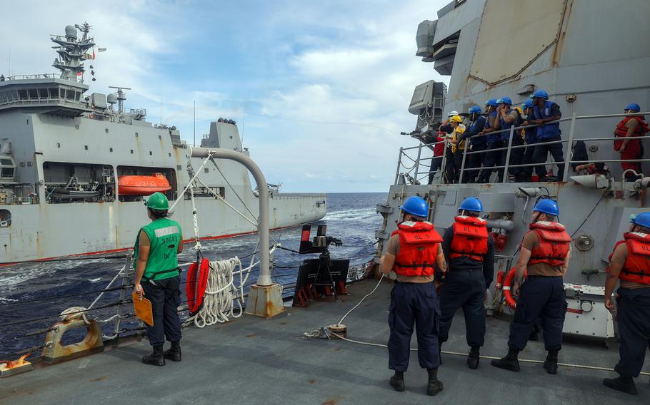 Sailors aboard the guided-missile destroyer USS Howard shoot a shot line on the fo’c’sle during a replenishment-at-sea with the New Zealand navy's  HMNZS Aotearoa in the South China Sea, Sep. 28. 2024.