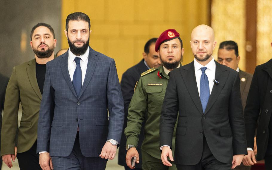 Syria’s de facto leader Ahmad al-Sharaa,  oreground left, formerly known as Abu Mohammed al-Golani, meets with Walid Ellafi, right, Libyan minister of state for communication and political affairs, in the presidential palace in Damascus, Syria, Saturday, Dec. 28, 2024. 