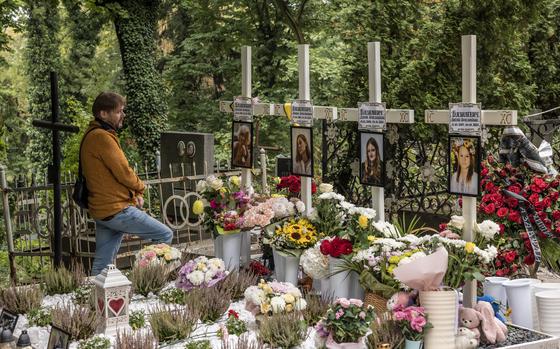 Yaroslav Bazylevych visits the graves of his family at the Lychakiv Cemetery in Lviv, Ukraine.