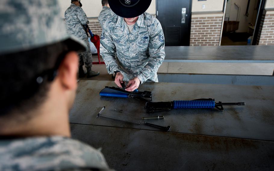 Air Force Tech. Sgt. Pete Silcox, an instructor with the 331st Training Squadron, demonstrates how to assemble the M16 trainer weapon, May 2, 2019, at Joint Base San Antonio-Lackland. These trainer weapons were recognizably marked with blue buttstock and hand guards. 