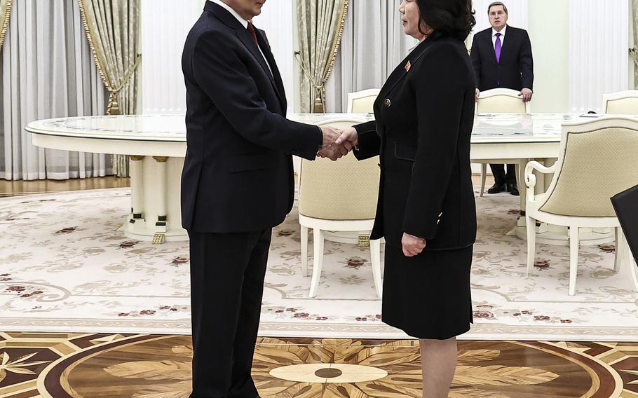 Russian President Vladimir Putin shakes hands with North Korean Foreign Minister Choe Son Hui.