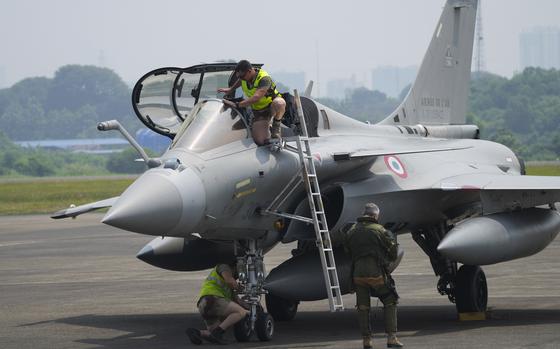 Crew members inspect a France's Rafale fighter jets during visiting Indonesia on the Pegase 2024 mission at Halim Perdanakusuma airport in Jakarta, Indonesia, Wednesday, July 24, 2024. (AP Photo/Tatan Syuflana)