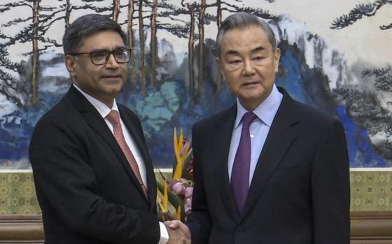 In this image taken from a video footage run by Phoenix TV, Chinese Foreign Minister Wang Yi, right, meets with India's Foreign Secretary Vikram Misri in Beijing, Monday, Jan. 27, 2025. (Phoenix TV via APTN)