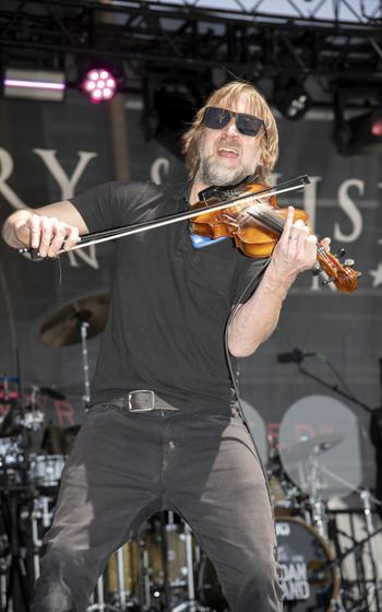 A man plays the violin on stage