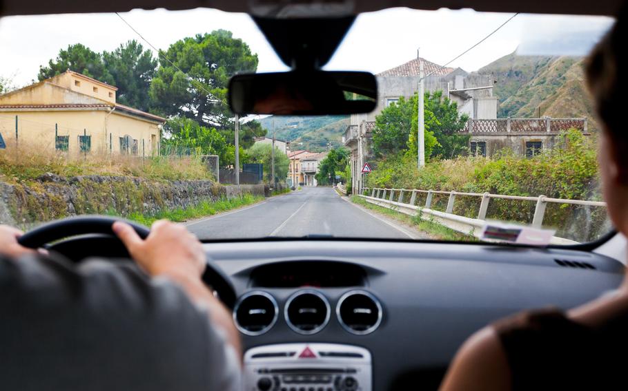 Driving a car on rural road in Italy