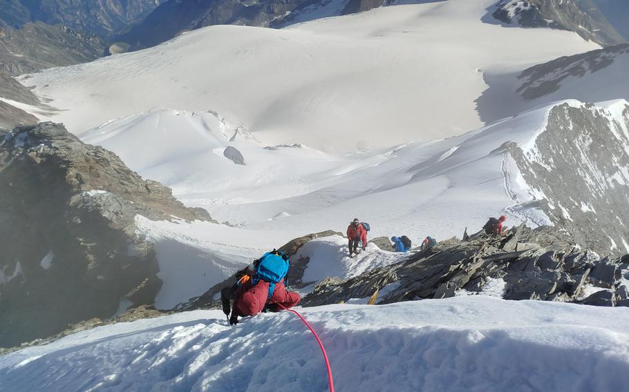 Cathy Morth, left, is the climbing partner of Malcolm Isbell, who taught mountaineering first aid at Ramstein Air Base and other alpinists scale the side of the 14,200 ft. Mt. Nadelhorn in Switzerland. This photo was taken by Isbell, who later met with Nicolaus Marshall and fellow climbing enthusiast who would have an emergency Isbell and Morth attended to.