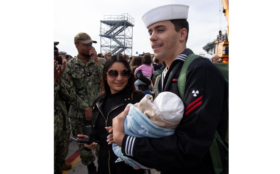 Machinist Mate Seaman Apprentice Capavon PazmioCurtis meets his newborn family member