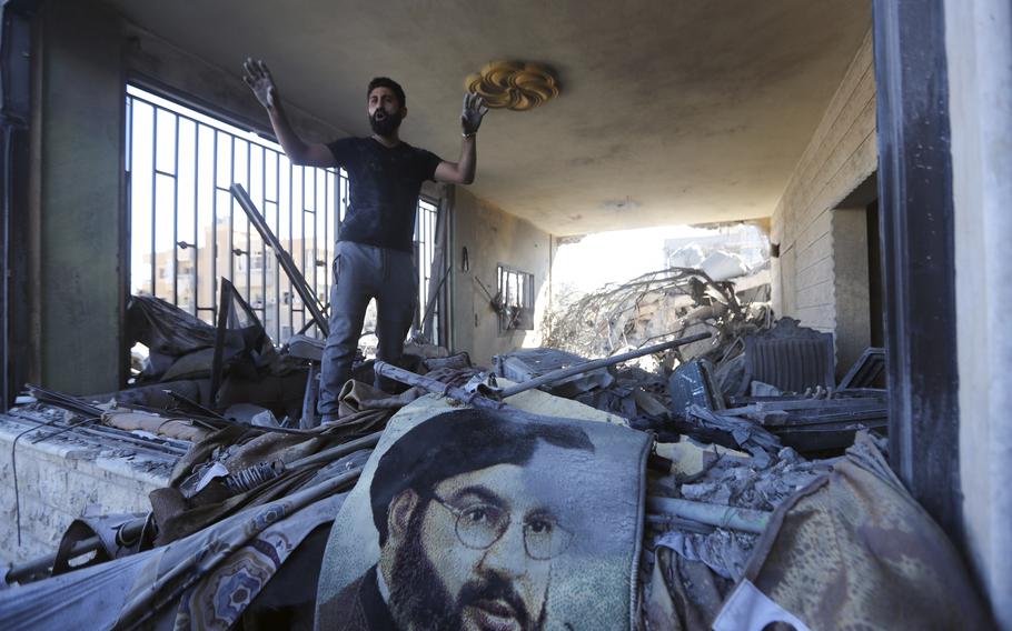 A man reacts surveys a damaged apartment in Saksakieh, Lebanon.