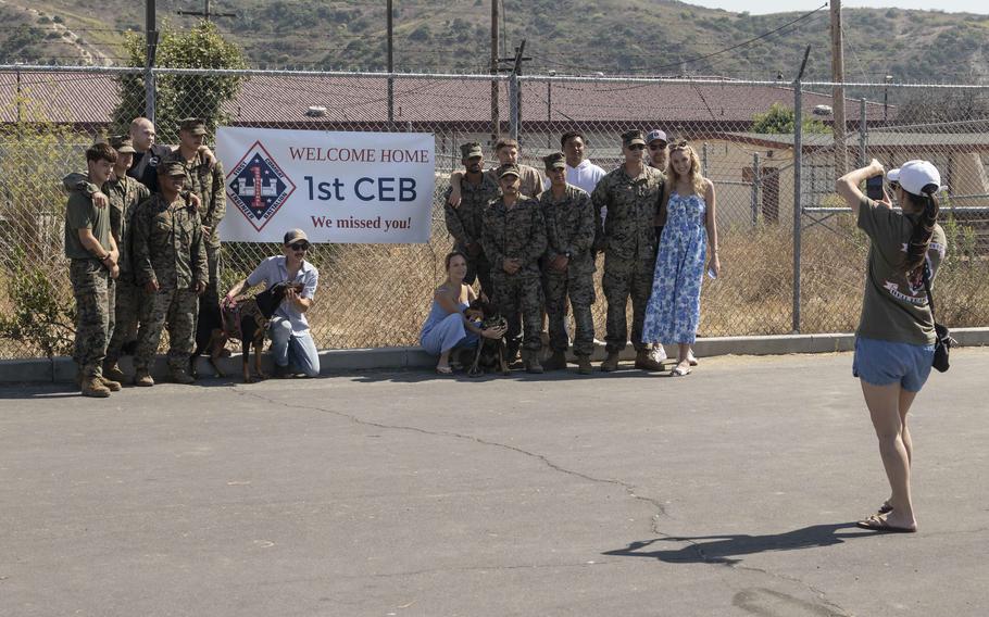 U.S. Marines attached to Battalion Landing Team 1/5, 15th Marine Expeditionary Unit, pose for a group photo with family and friends at Marine Corps Base Camp Pendleton, Calif., on Aug. 10, 2024, after returning from deployment.