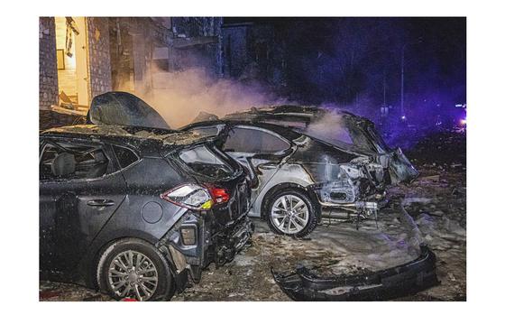 Cars burn after a Russian rockets attack that hit a hotel in Kharkiv, Ukraine, late on Jan. 10, 2024.